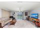 Comfortable living room with sliding glass doors that reveal the inviting backyard pool area at 107 Corot Dr, Nokomis, FL 34275