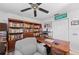 Home office featuring a wall of bookshelves and a large wooden desk at 107 Corot Dr, Nokomis, FL 34275