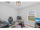 Cozy office with a glass desk, window with blinds, and wood-look floors at 107 Corot Dr, Nokomis, FL 34275