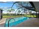 Enclosed pool area with a large screened-in enclosure and a clear blue swimming pool at 107 Corot Dr, Nokomis, FL 34275