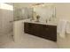 Bathroom featuring double vanity, framed mirror, tile flooring, glass enclosed shower, and neutral color palette at 10768 Trophy Dr, Englewood, FL 34223