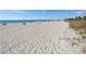 Wide sandy beach with clear turquoise water, beachgoers, and plenty of space for relaxation at 10768 Trophy Dr, Englewood, FL 34223