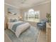 Well-lit bedroom featuring a beach-themed decor, soft blue accents, and arched window at 10768 Trophy Dr, Englewood, FL 34223