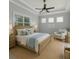 Comfortable bedroom with a large window and a sitting area at 10768 Trophy Dr, Englewood, FL 34223