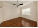 Bedroom featuring wood floors, a ceiling fan, and a window that provides plenty of natural light at 10768 Trophy Dr, Englewood, FL 34223