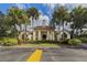 Clubhouse exterior surrounded by lush landscaping, showcasing an elegant entrance to community amenities at 10768 Trophy Dr, Englewood, FL 34223