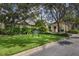 Exterior view of the Boca Royale clubhouse, featuring lush landscaping and well-maintained grounds at 10768 Trophy Dr, Englewood, FL 34223