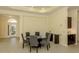 Elegant dining area featuring a glass-top table, six chairs, and stylish decor with view to front entry at 10768 Trophy Dr, Englewood, FL 34223