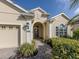Attractive front exterior featuring manicured landscaping, a brick walkway, and a well-maintained lawn at 10768 Trophy Dr, Englewood, FL 34223