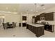 Spacious kitchen with an island, stainless steel appliances, and an adjacent dining area at 10768 Trophy Dr, Englewood, FL 34223