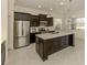 Contemporary kitchen with an island, stainless steel appliances, and ample natural light at 10768 Trophy Dr, Englewood, FL 34223