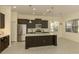 Modern kitchen featuring stainless steel appliances, granite countertops, and a center island at 10768 Trophy Dr, Englewood, FL 34223