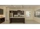 Bright kitchen with stainless steel appliances, an island and natural light at 10768 Trophy Dr, Englewood, FL 34223