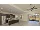 Modern kitchen with a center island, stainless appliances, and a view to the outside patio at 10768 Trophy Dr, Englewood, FL 34223