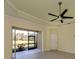 Spacious living room with sliding glass doors and backyard view at 10768 Trophy Dr, Englewood, FL 34223