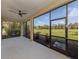 Relaxing screened patio with ceiling fan and view of green space, perfect for outdoor living at 10768 Trophy Dr, Englewood, FL 34223