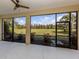 Screened-in patio with an expansive view of the lush, green backyard at 10768 Trophy Dr, Englewood, FL 34223