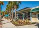 Charming retail shops along a street lined with palm trees and pedestrian-friendly sidewalks at 10768 Trophy Dr, Englewood, FL 34223