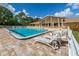 Community pool with lounge chairs, tables, and ample space for relaxing at 1118 Southlake Ct, Venice, FL 34285