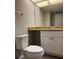 Bathroom with a single sink, a large mirror, and a toilet at 1190 Longfellow Way # 135C, Sarasota, FL 34243