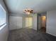 Bedroom with carpeted floors, closet, ceiling fan, and window at 1190 Longfellow Way # 135C, Sarasota, FL 34243