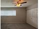 Bedroom with carpeted floors, closet, ceiling fan, and window at 1190 Longfellow Way # 135C, Sarasota, FL 34243
