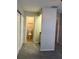 Bedroom with ensuite bathroom and walk-in closet, featuring neutral carpet flooring at 1190 Longfellow Way # 135C, Sarasota, FL 34243
