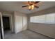 Bedroom with carpeted floors, closet, ceiling fan, and window at 1190 Longfellow Way # 135C, Sarasota, FL 34243