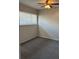 Cozy bedroom with carpet flooring, bright window, and ceiling fan at 1190 Longfellow Way # 135C, Sarasota, FL 34243
