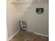 The laundry area is equipped with a wire shelf, hookups, and vinyl flooring at 1190 Longfellow Way # 135C, Sarasota, FL 34243