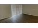 Bright living room with wood floors and sliding glass door for natural light at 1190 Longfellow Way # 135C, Sarasota, FL 34243