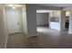 Open floor plan with gray walls, wood-look flooring, a front door and a view of the kitchen at 1190 Longfellow Way # 135C, Sarasota, FL 34243