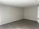 Empty living room with light gray walls and gray, wood-look flooring at 1190 Longfellow Way # 135C, Sarasota, FL 34243