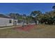 Community playground area featuring swings on a mulch bed next to the pool at 1190 Longfellow Way # 135C, Sarasota, FL 34243