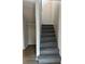 Carpeted staircase leading to the upper level, next to a storage area at 1190 Longfellow Way # 135C, Sarasota, FL 34243