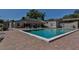 Community swimming pool area with lounge chairs and an expansive patio at 1190 Longfellow Way # 135C, Sarasota, FL 34243
