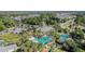 Aerial view of the community clubhouse and luxurious pool area surrounded by lush landscaping and well-maintained grounds at 11917 Hunters Creek Rd, Venice, FL 34293