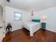 Comfortable bedroom with hardwood floors, decorative chandelier, and stylish accents at 1200 Yawl Way, Venice, FL 34285