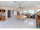 Spacious bonus room with tile floors, many windows, a ceiling fan and large work tables at 1200 Yawl Way, Venice, FL 34285