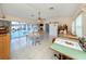 Bonus room with a ceiling fan, white tile flooring, and access to a screened-in pool area at 1200 Yawl Way, Venice, FL 34285
