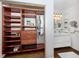 Spacious walk-in closet with custom shelving, built-in drawers, leading to modern bathroom at 1200 Yawl Way, Venice, FL 34285