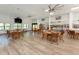 Spacious clubhouse with tables, chairs, and a TV, perfect for gatherings at 1200 Yawl Way, Venice, FL 34285