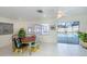 Bright dining area with white tile floors and glass sliders leading to the pool area at 1200 Yawl Way, Venice, FL 34285