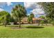 Community clubhouse nestled among lush green trees and landscaping at 1200 Yawl Way, Venice, FL 34285