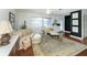 Bright and airy living room with wood floors, large windows, and eclectic decor at 1200 Yawl Way, Venice, FL 34285