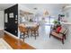 Open-concept living area with tile floors, wicker chairs, and abundant natural light at 1200 Yawl Way, Venice, FL 34285