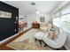 Bright and airy living room with wood floors, large windows, and eclectic decor at 1200 Yawl Way, Venice, FL 34285
