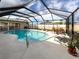 Beautiful screened-in pool area with outdoor dining and lounge chairs at 1200 Yawl Way, Venice, FL 34285