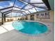 Screened-in pool area with a sparkling pool and outdoor seating, perfect for relaxation at 1200 Yawl Way, Venice, FL 34285