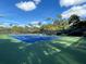 Vibrant blue and green tennis court at Eagle Point Club, perfect for recreational play and exercise at 1200 Yawl Way, Venice, FL 34285